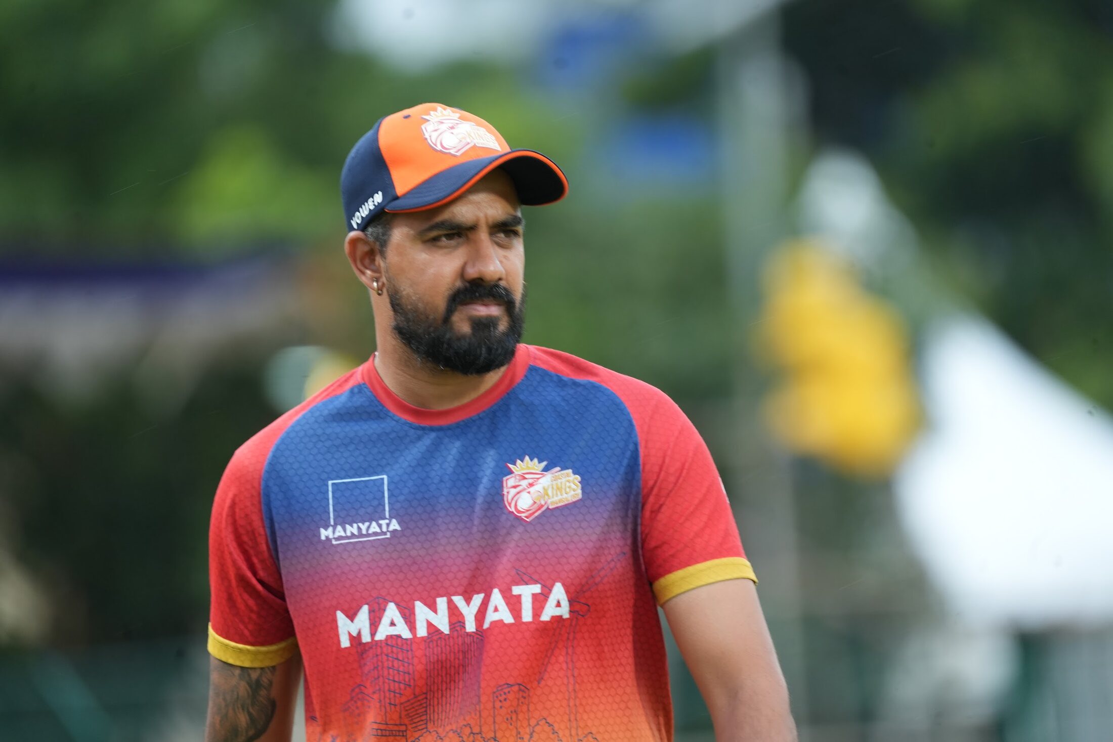 Kartik Achappa watching training from the field