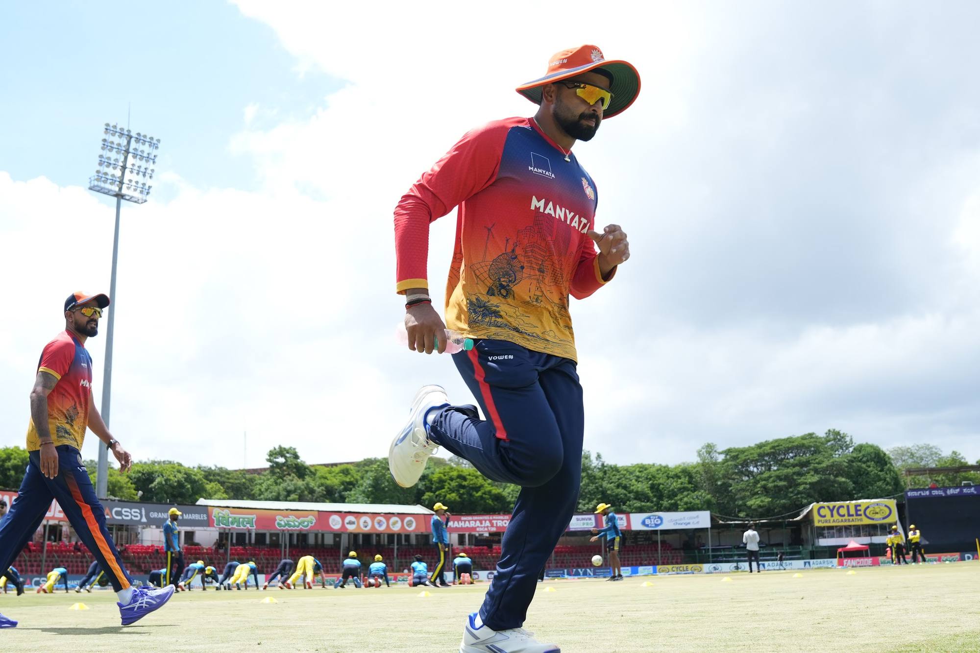 Kartik Achappa running on the outfield before a Maharaja Trophy match
