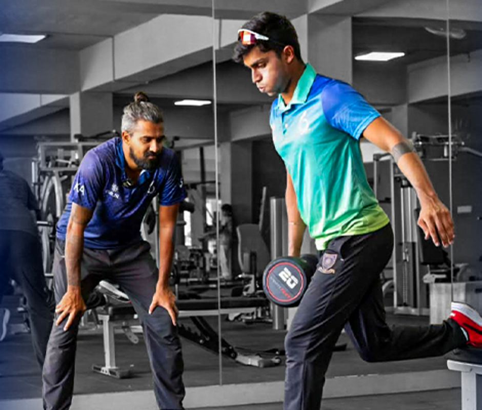 Kartik Achappa coaching an athlete in the SIX Cricket gym