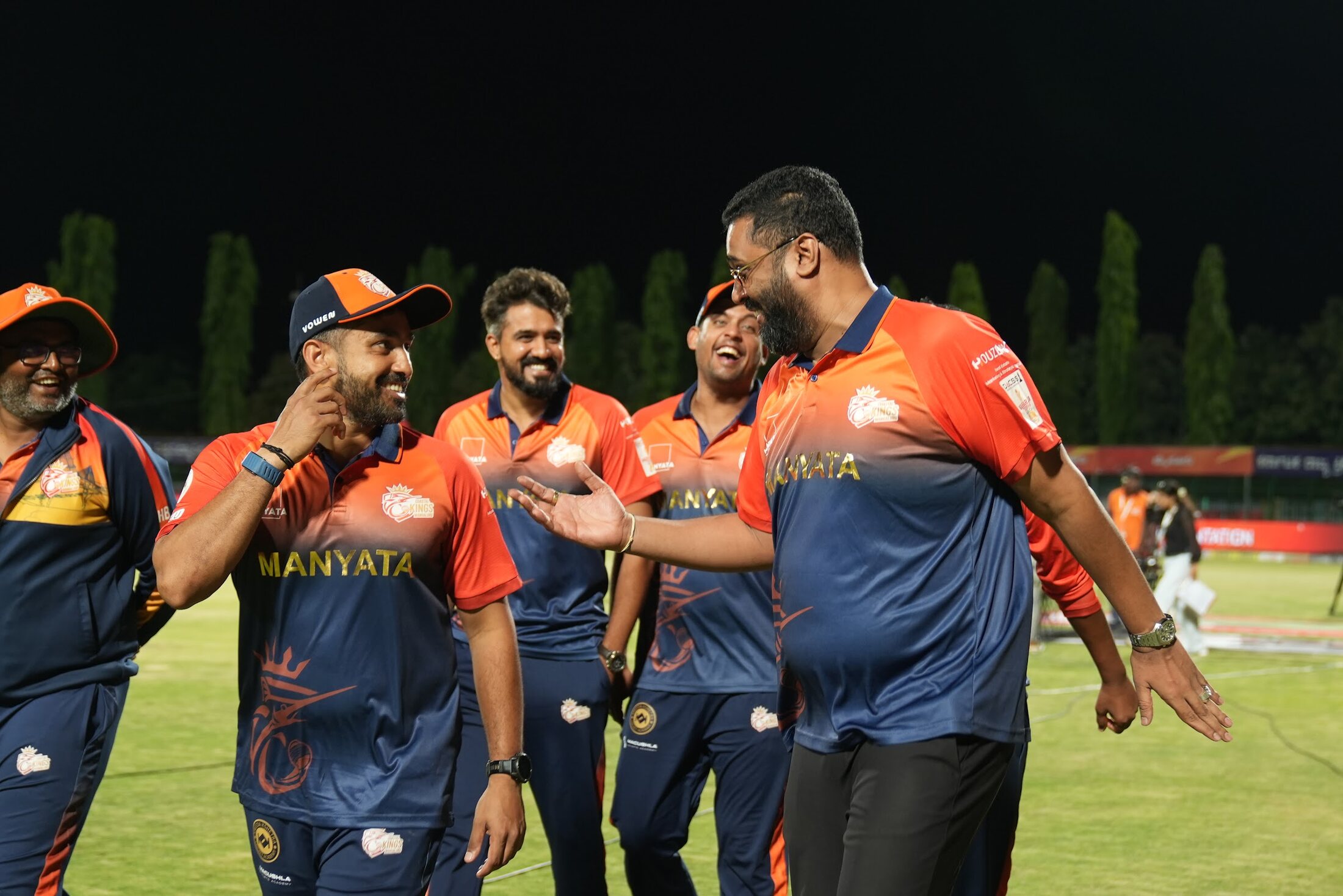 Kartik Achappa with a cricket support team on the field